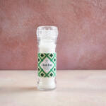 Maldon Original Sea Salt 55g grinder. Pink background.