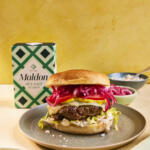 Homemade summer beef burger. Paired with pickled red onions, lettuce, cheese and mustard. Seasoned with Maldon Original Sea Salt 250g pack.