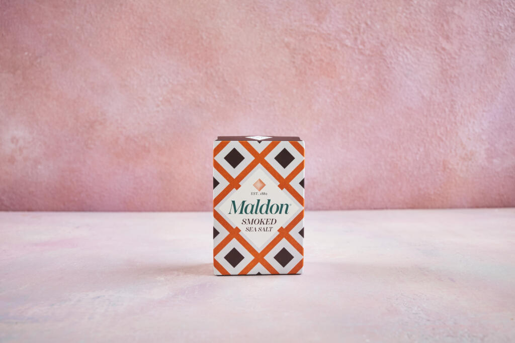 Maldon Smoked Sea Salt 125g pack. Pink background.