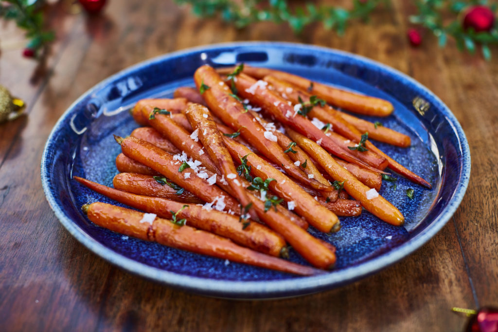 Roasted carrots on blue plate