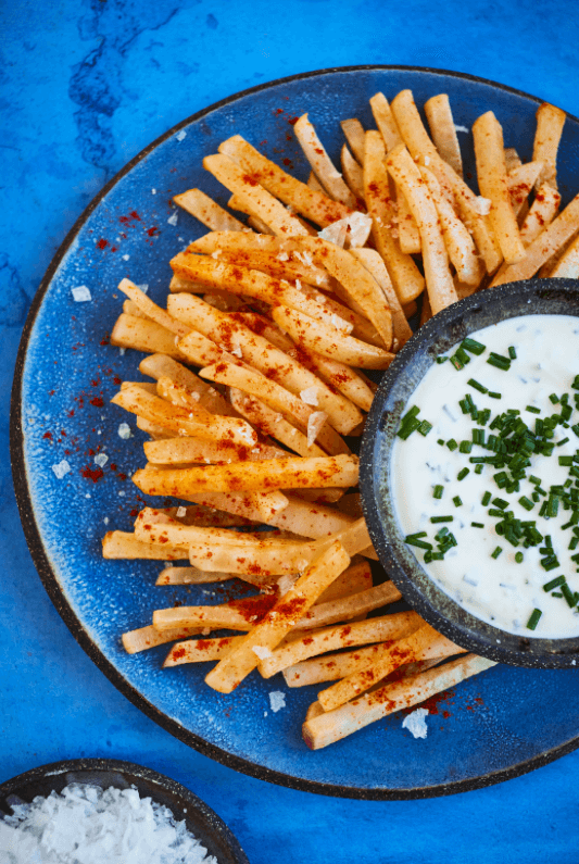 Crispy turnip fries on plate with sour cream and chive dip
