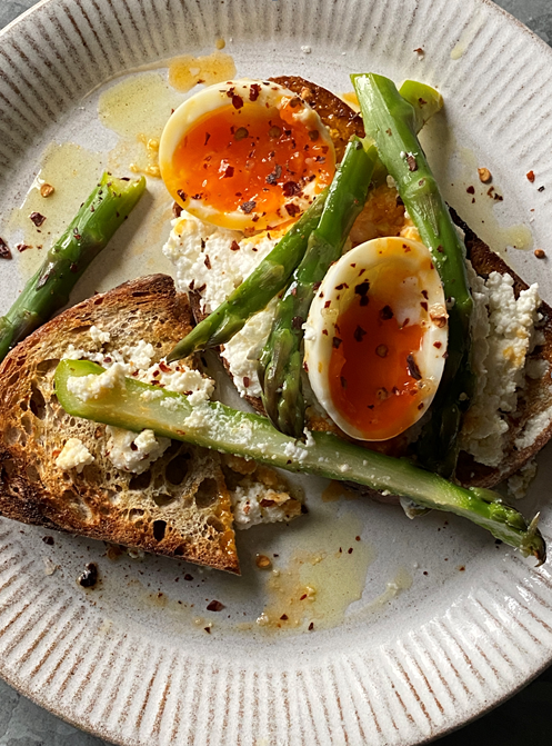 Asparagus and eggs on toast topped with Aleppo pepper