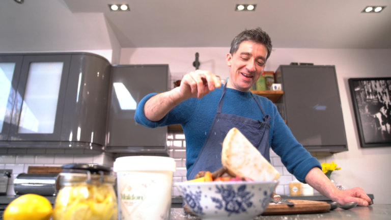Ben Tish sprinkles Maldon Salt onto his dish from shoulder height.