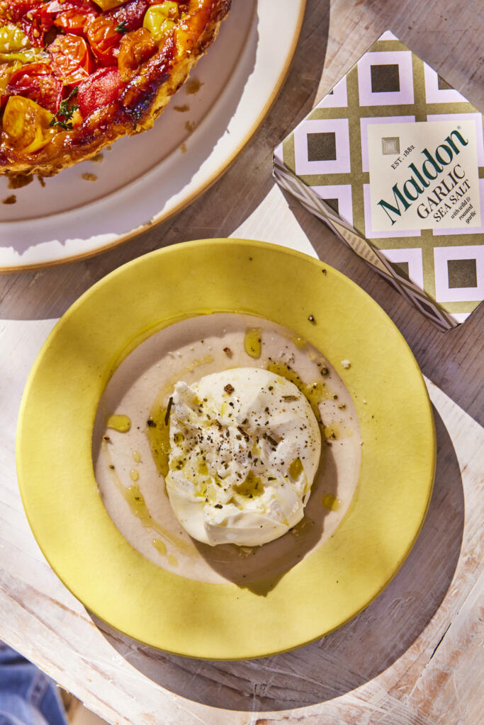 Maldon Garlic Sea Salt 100g pack. Paired with burrata cheese and a tomato tarte Tatin.