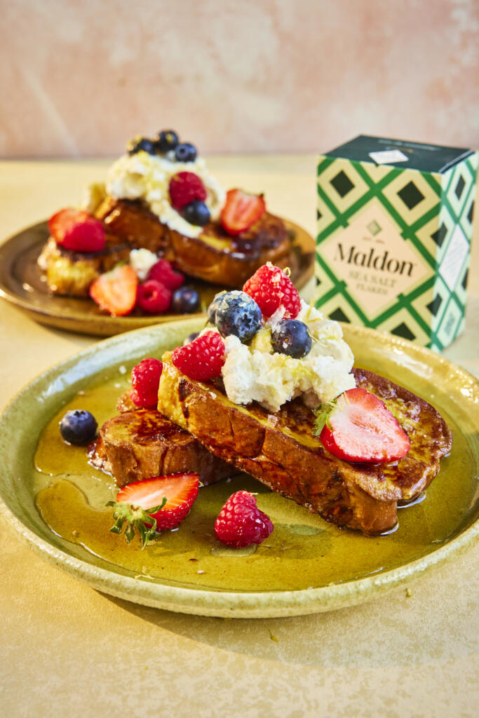 French toast with whipped ricotta, topped with strawberries, blueberries and raspberries. Drizzled with maple syrup and a pinch of Maldon Sea Salt flakes.