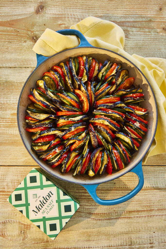 Ratatouille with layers of thinly sliced aubergine, courgette and tomatoes. Topped with a pinch of Maldon Sea Salt flakes.