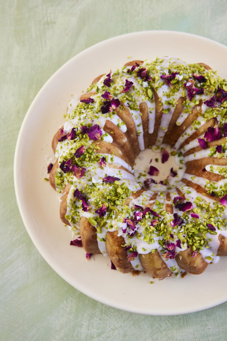 Pistachio, Rose & Cardamom Bundt Cake with icing sugar and Maldon Sea Salt on top.