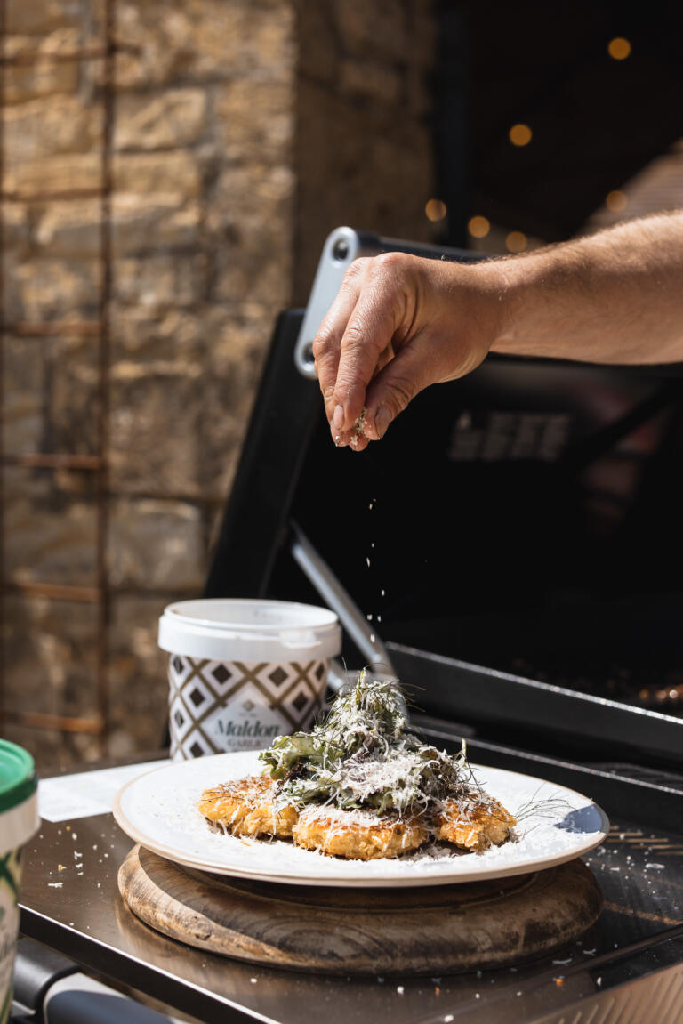 Grilled chicken schnitzel meets smoky BBQ flair in this Caesar salad twist—crispy, juicy, and tossed with creamy dressing, crisp romaine, and shaved parmesan.