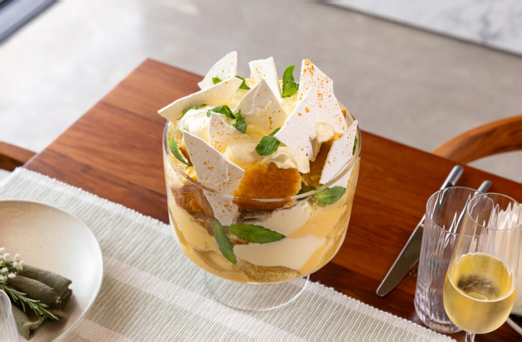Festive Mojito trifle showing layers of olive oil sponge, lime and mint curd, lemonade jelly, Chantilly cream, and crisp meringue, topped with Maldon Sea Salt.